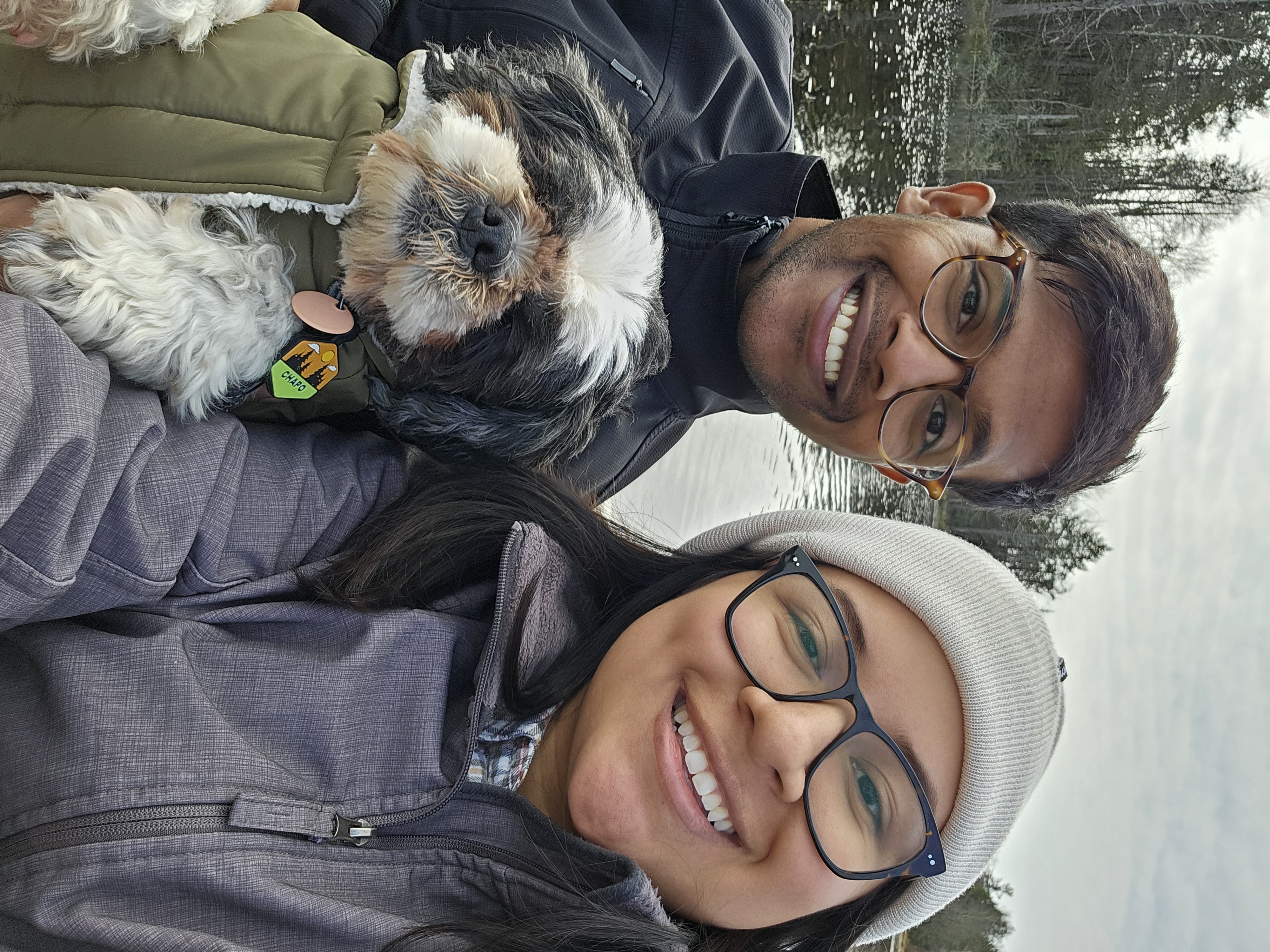Tiffany and Aravind with their dog in the snow