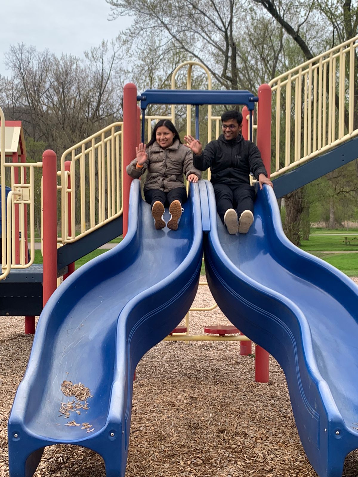 Tiffany and Aravind on playground slides