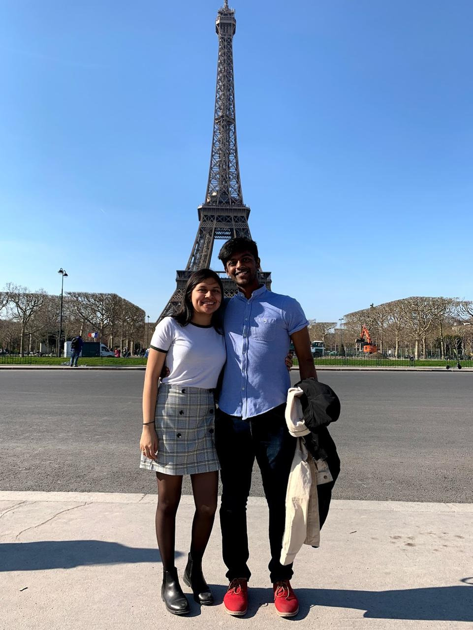 Tiffany and Aravind in front of the Eiffel Tower in Paris