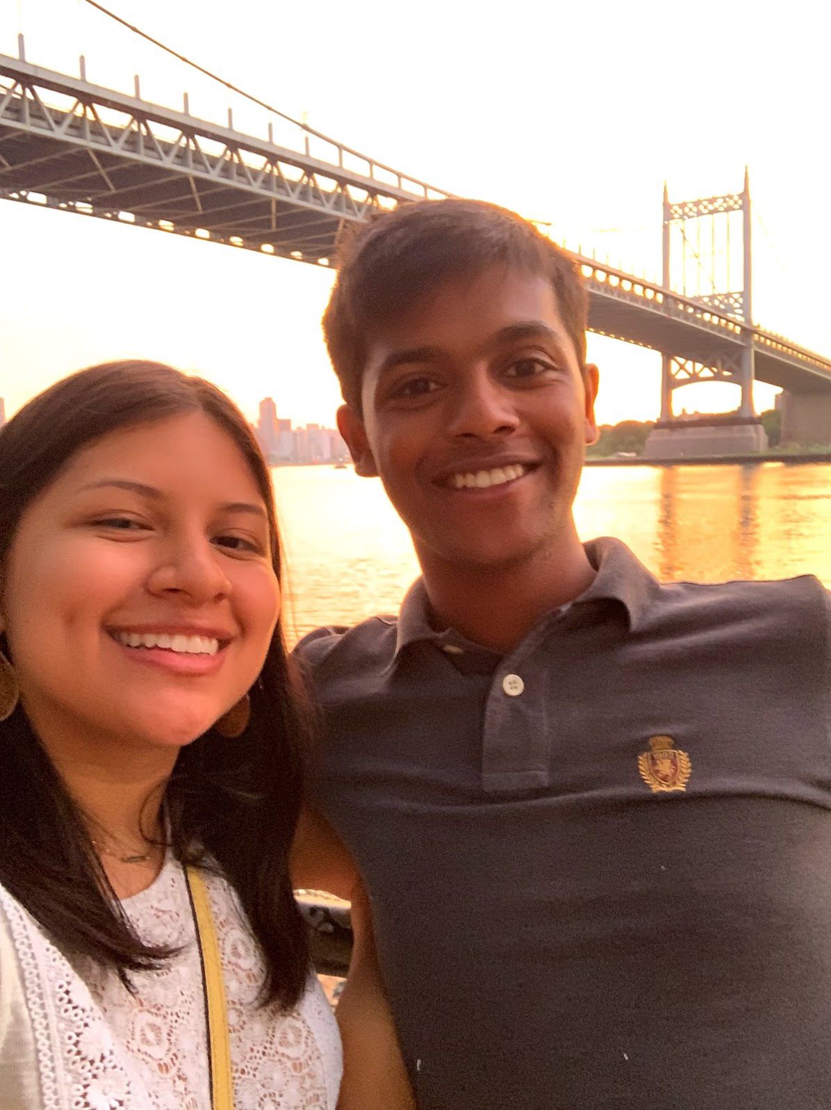 Tiffany and Aravind selfie at sunset by the bridge in New York